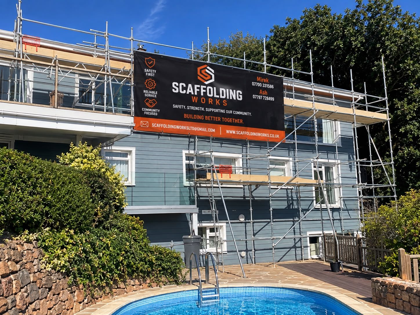 Scaffolding around a Jersey home with a Scaffolding Works banner